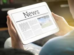 Image of hands holding a tablet reading the news