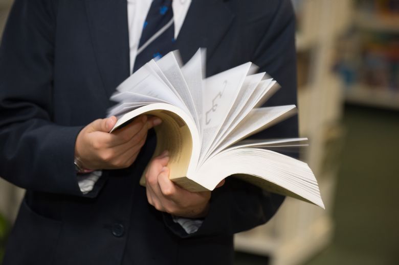 Hands flipping book pages