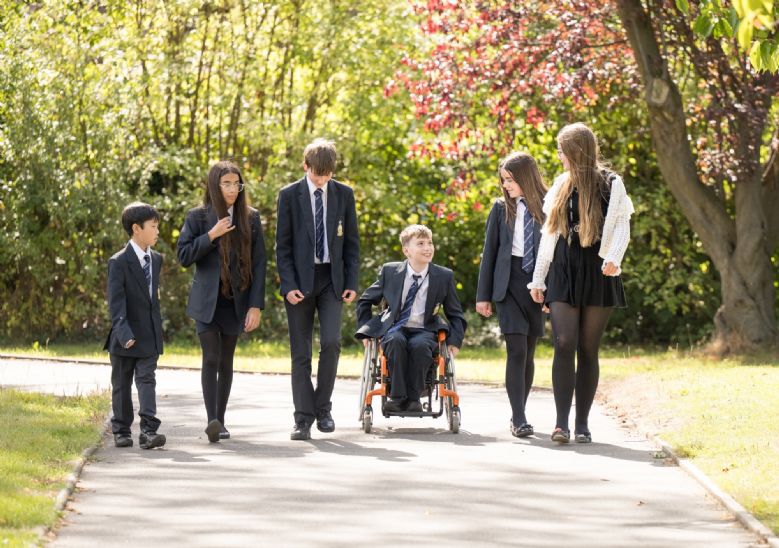 Group of students sitting and standing in correct uniform