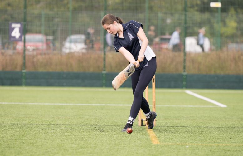  Female student playing cricket