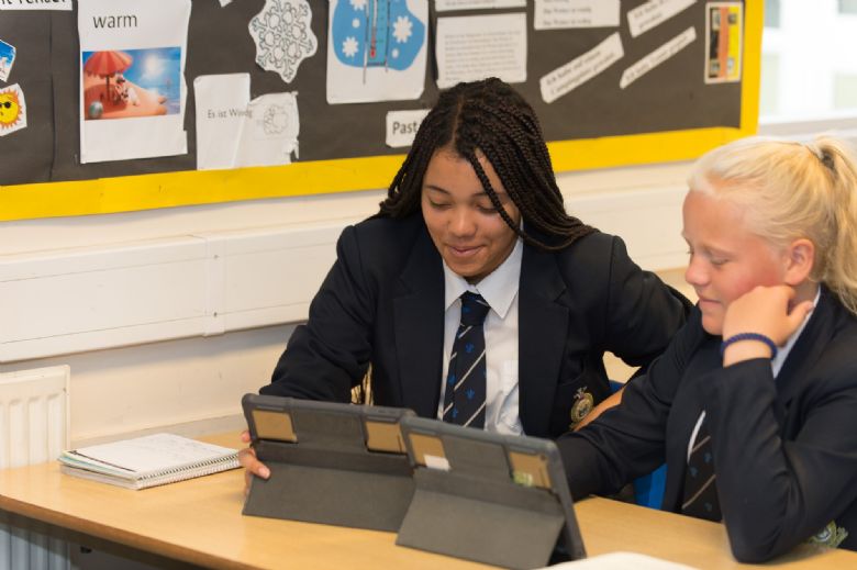 Two girls using an iPad